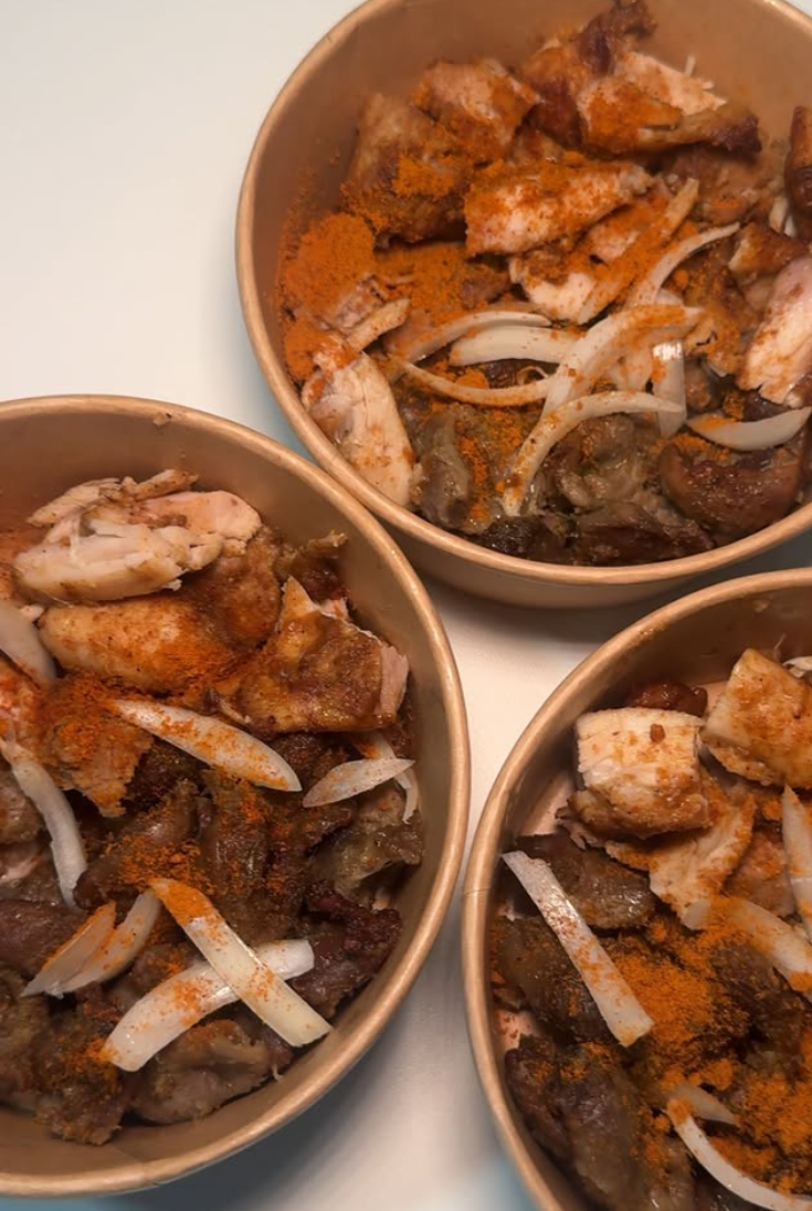 Bowls of peppered assorted grilled meat with onions and spice